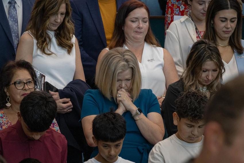 Attendees of the ribbon cutting event at Legacy Elementary take a moment to pray Oct. 10, 2025.