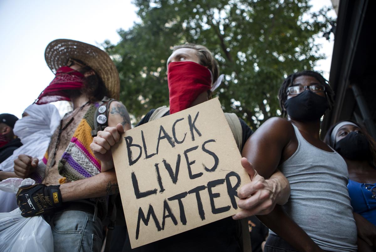 Protesters march east on Seventh Street in downtown Austin. The group marched in protest over the death of George Floyd during an arrest by the Minneapolis police department.
